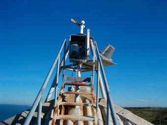 Stairs to reach the equipment, antenna on a platform, electronics in an adapted box, the instrument is measuring.