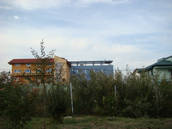 Dobrogea Seismological Observatory, a branch of the Romanian National Institute for Earth Physics, a view of the building from the sea shore side. The sunphotometer #397 is visible on the rooftop terrace of the building.