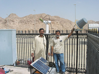 Cimel sunphotometer at Jabal Hafeet site with engineers Omar (left) and Mohammed Ramzan (right) pictured.