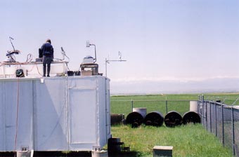A view of the instrument site with foothills in the distance.