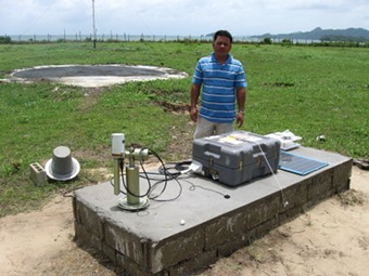 View of the sunphotometer with site manager Mesach Famat Rosette.