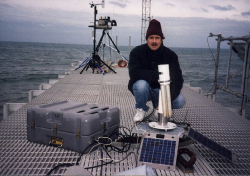 A view of the sun photometer near the ocean and Alexander Smirnov.