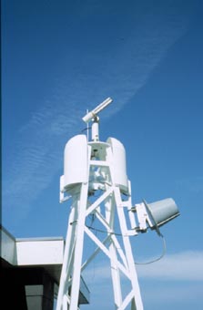 A view of the sunphotometer on a mast with a remote controlled cover for weather protection.
