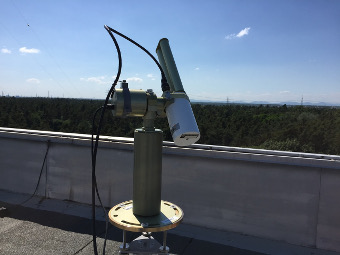 AERONET Station �KITcube_Karlsruhe� with Cimel CE318TP9-T installed on a rooftop at KIT Campus North with view to the west. In the background you can see the refineries of Karlsruhe and further west the mountains of Palatine Forest.
