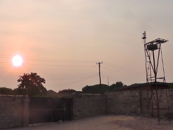 IN MONGU ZAMBIA, SHOWING SOUTHEASTERLY VIEW OF 6.5 METER TOWER AND SECURITY FENCE/GATE WITH SUN PHOTOMETER MOUNTED ON TOWER.