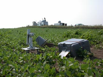 A view of the instrument site in a soybean field looking toward the northeast with skyward-looking LIDARs in the background. 